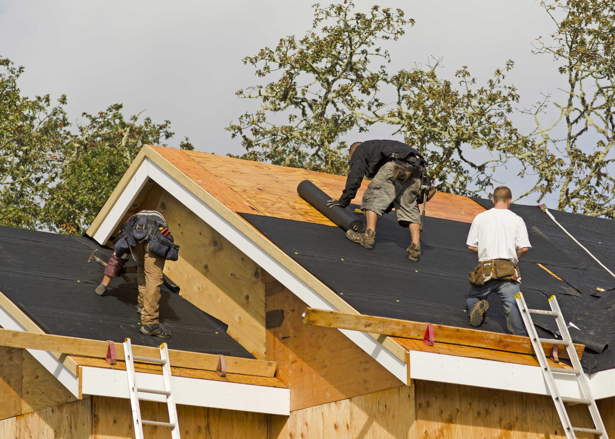 Professional roofers working on a home